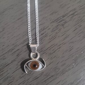 silver chain with a brown eye